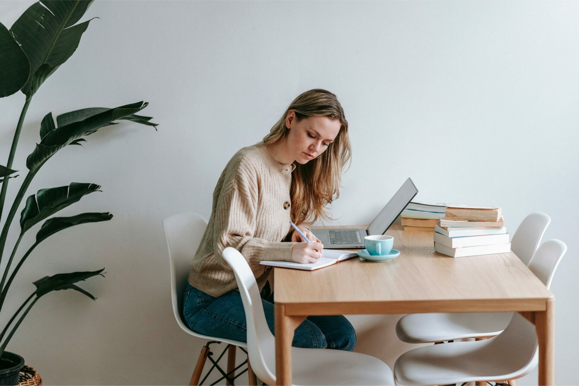 Student woman blonde with laptop and books