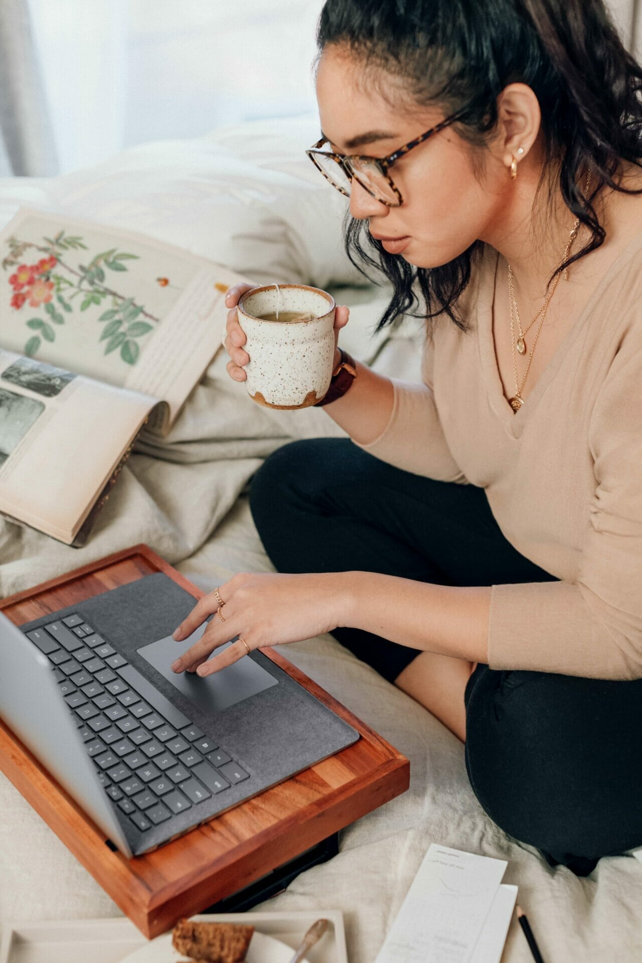 Student woman using laptop and tea